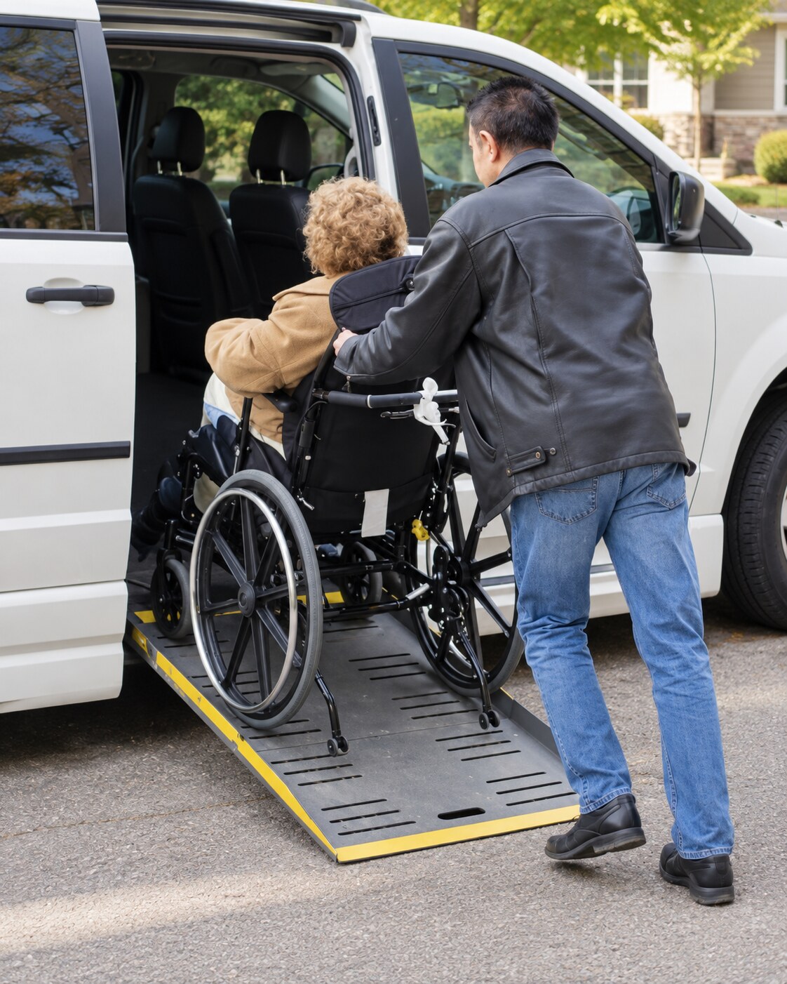 A passenger receiving assistance while boarding an accessible van